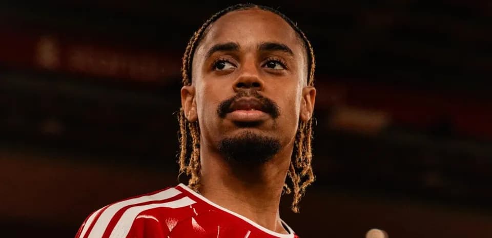 Player posing in red team jersey indoors