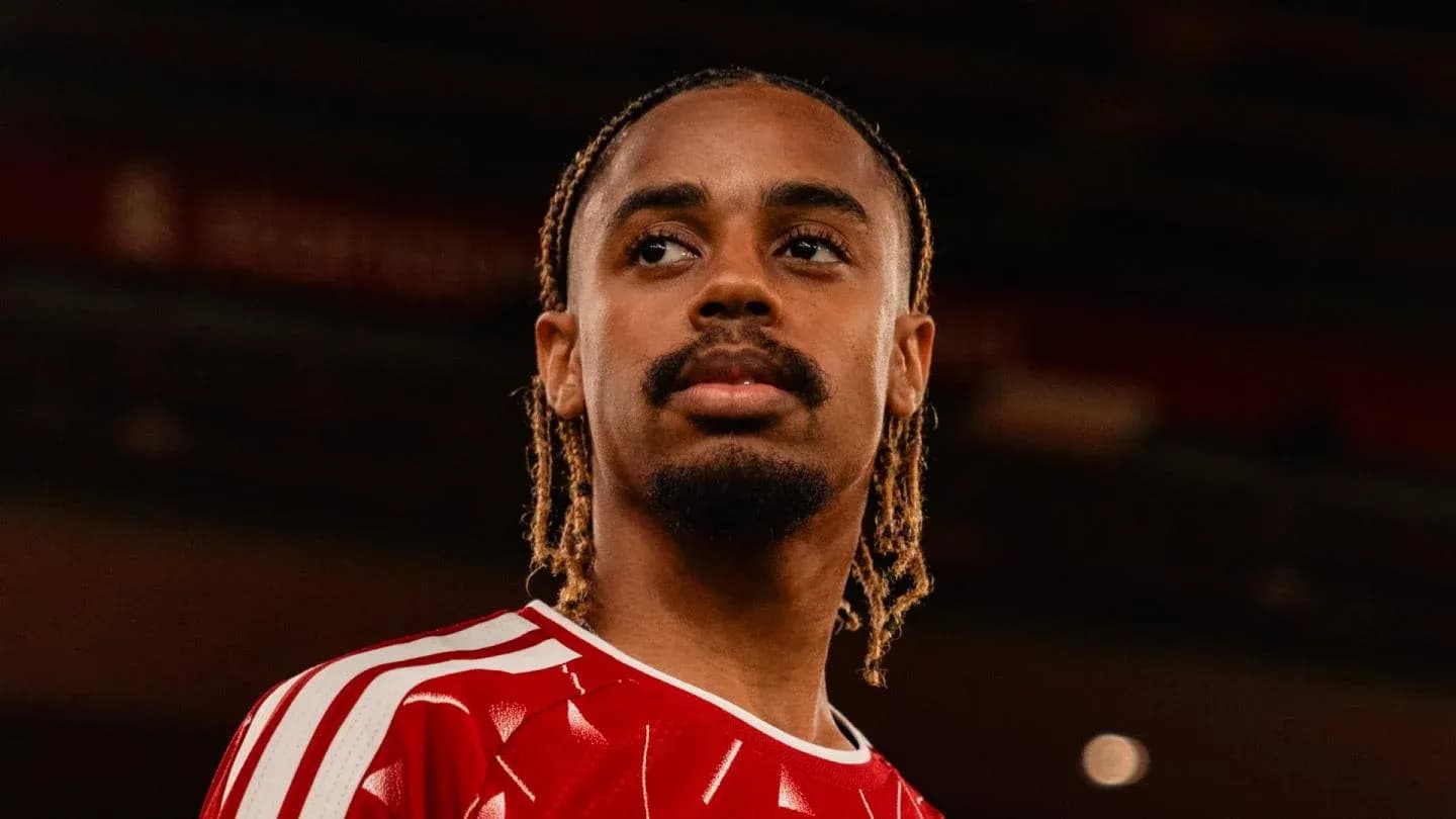 Player posing in red team jersey indoors
