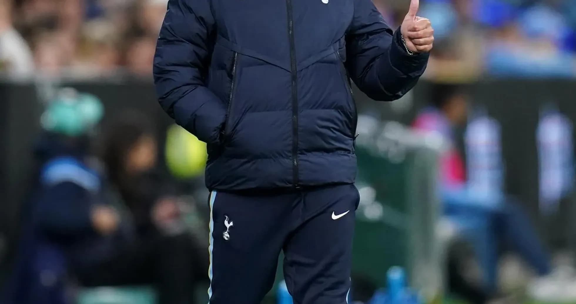 Manager walking on sideline giving thumbs up