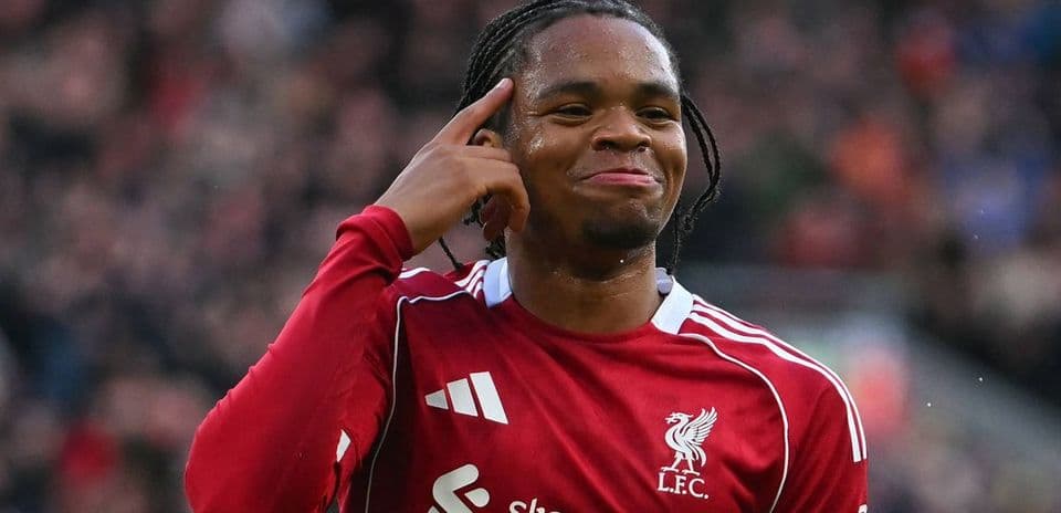Player celebrating with a hand gesture on pitch