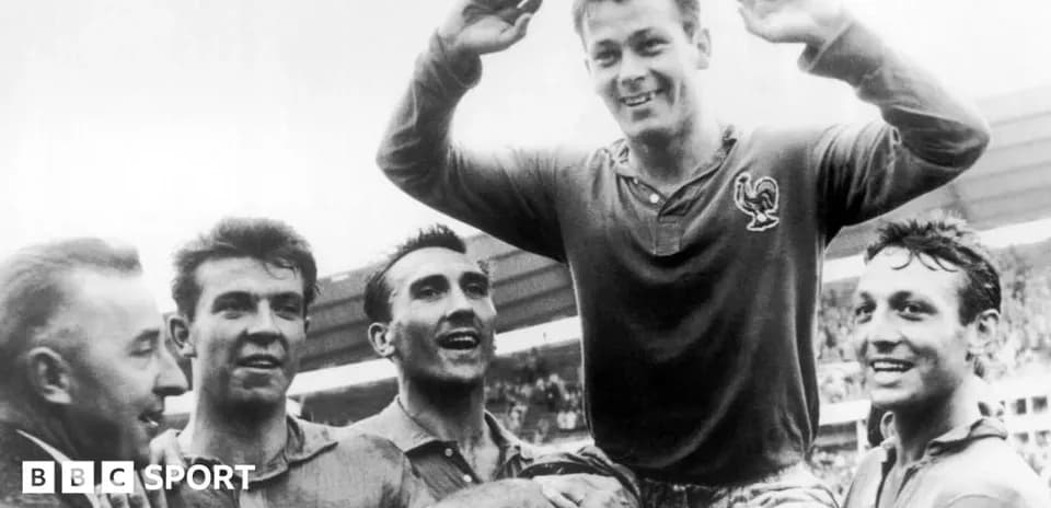 Players celebrating a victory with one lifted on shoulders