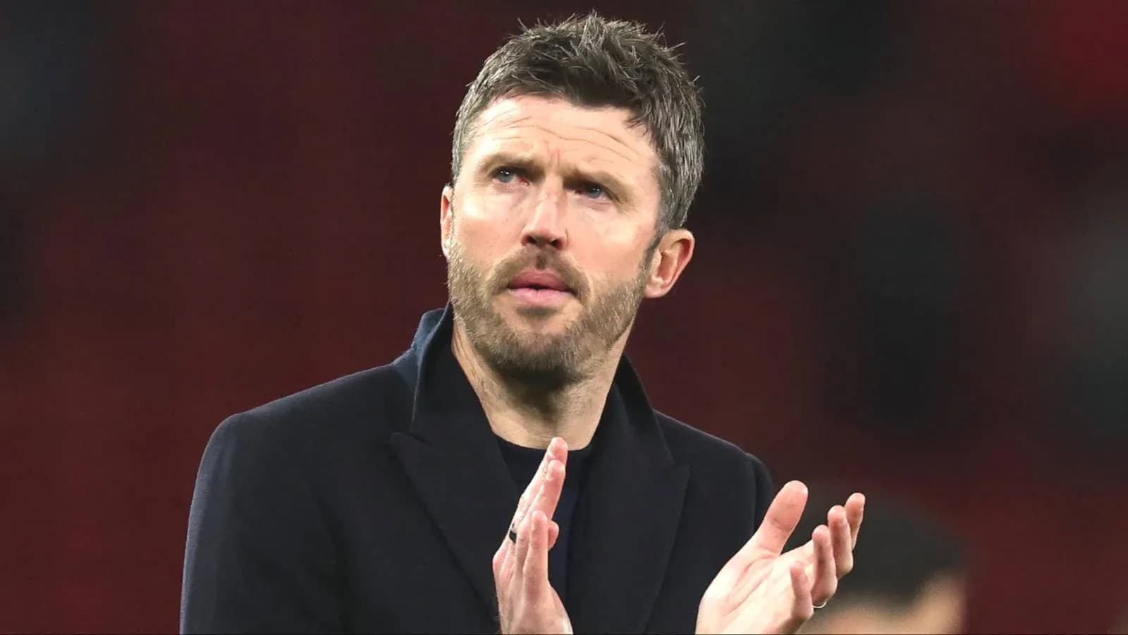 Coach applauding on the sidelines during match