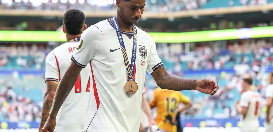 Player walking off field wearing a medal