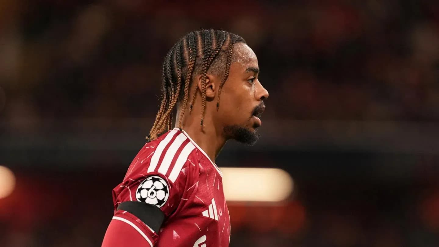 Player in red jersey during match, profile view