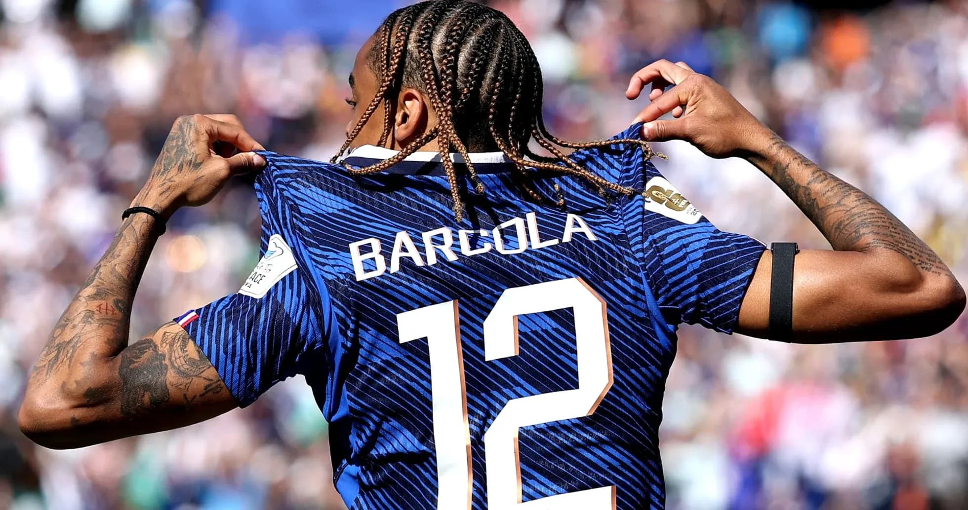 Player showing jersey with name and number 12