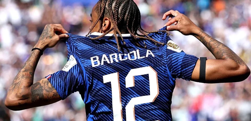 Player showing jersey with name and number 12