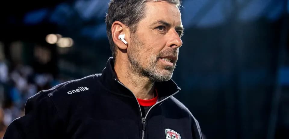 Coach with earbuds observing the match