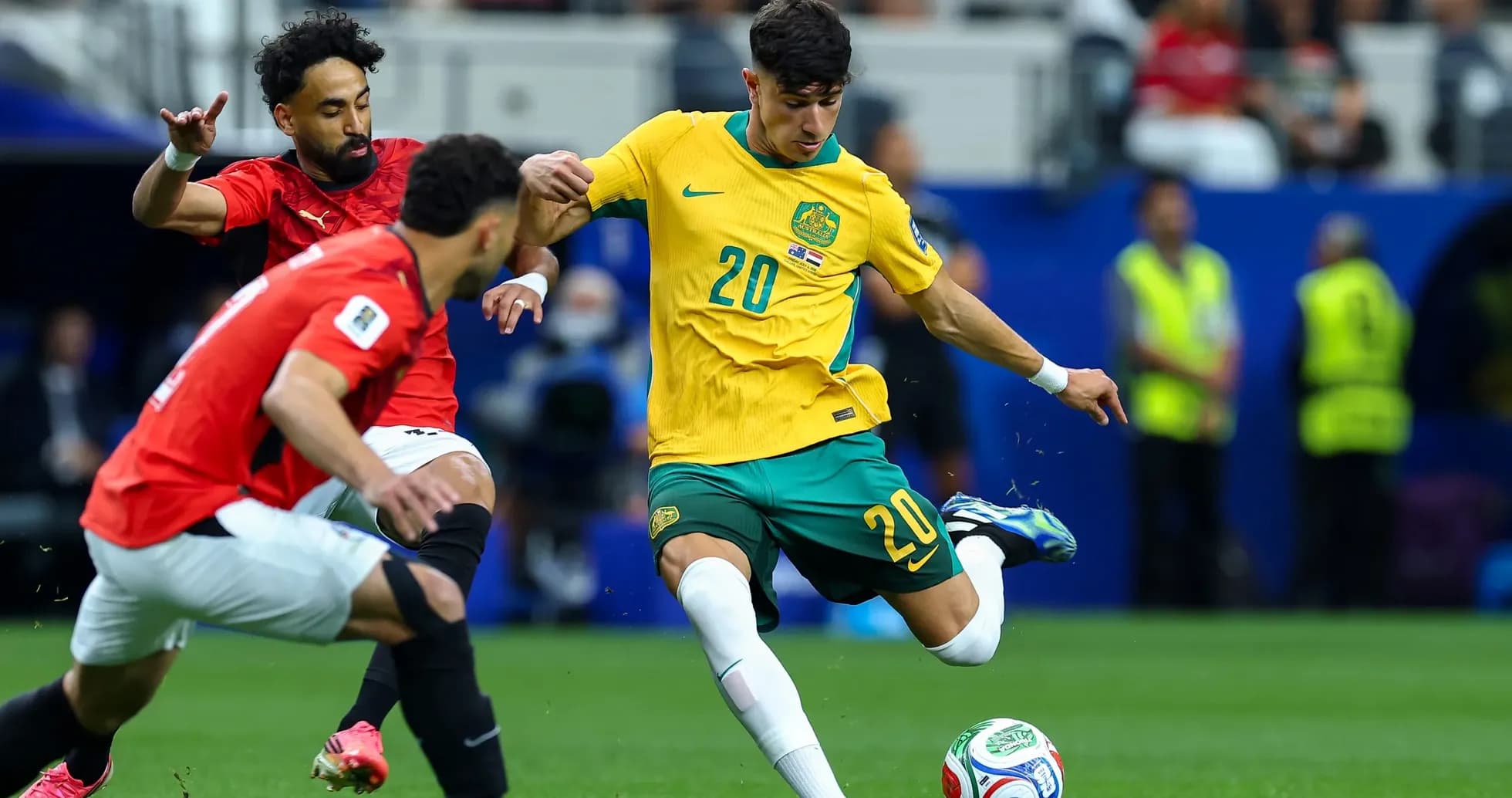 Australia player dribbling against Egypt in match