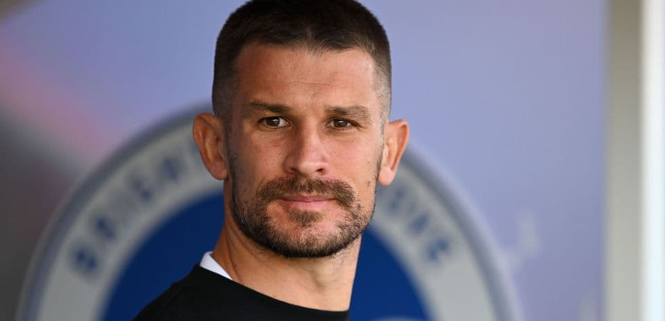 Man with short hair and beard posing for photo
