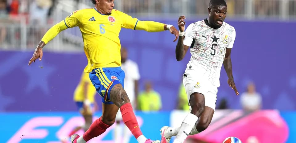 Colombia player tackles Ghana player during match