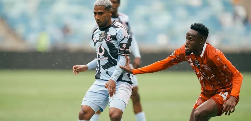 Player in striped jersey evading opponent during match