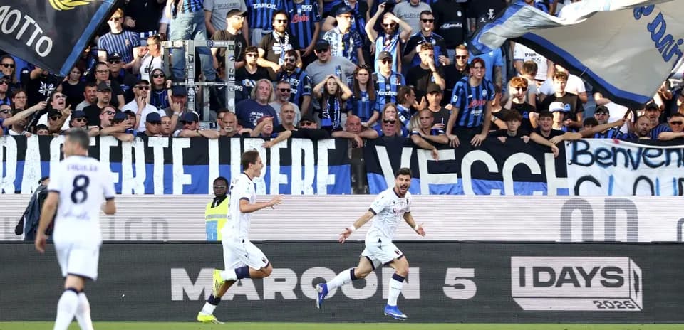 Players celebrating in front of Atalanta fans