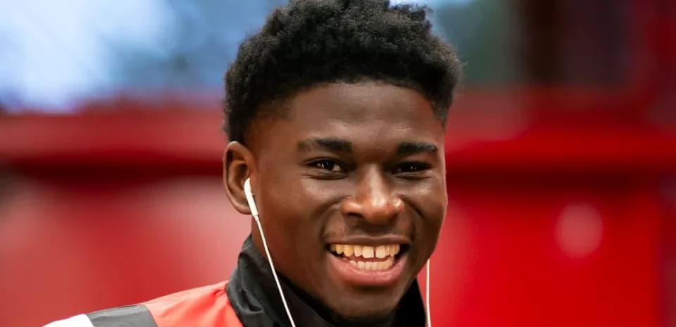 Player smiling while wearing headphones in training gear