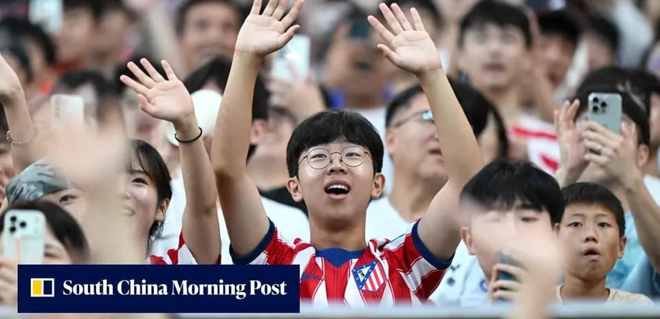 Young fan cheering in Atlético Madrid jersey