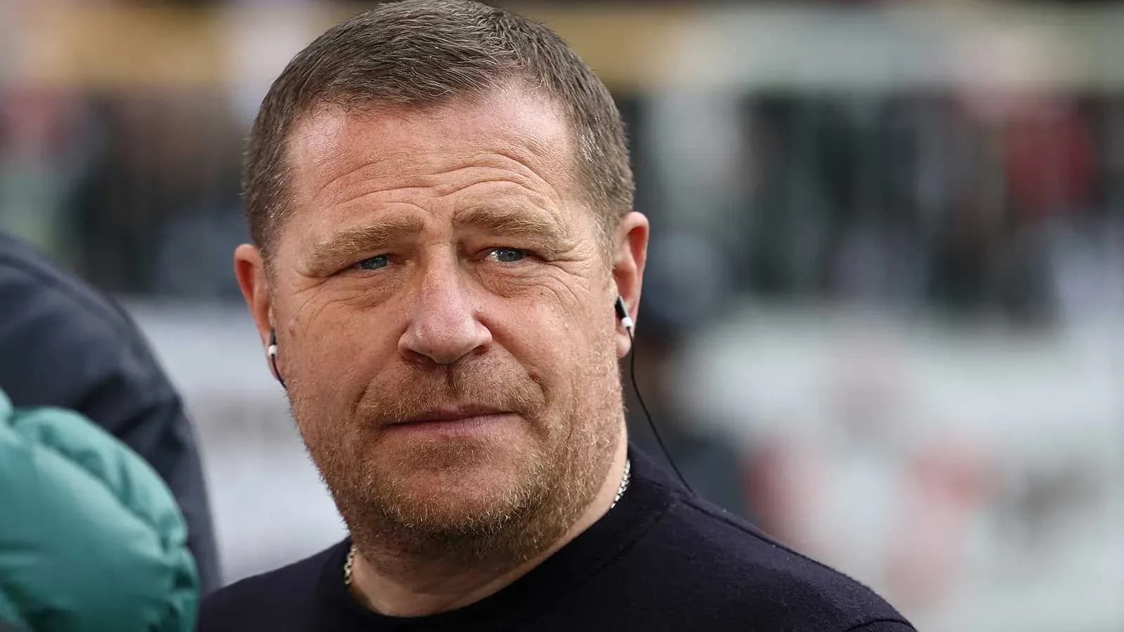 Man with earphones at a sports event