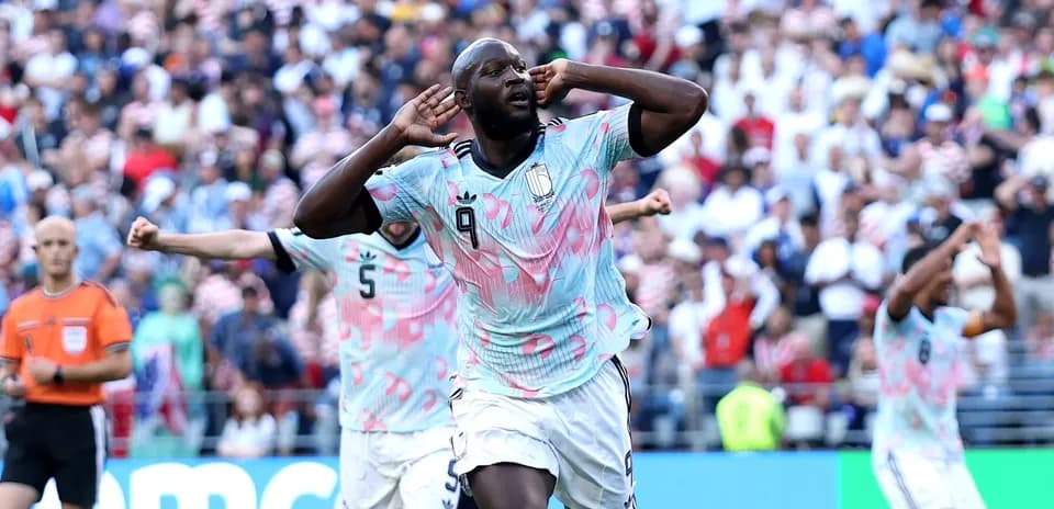 Player celebrating a goal with teammates in match