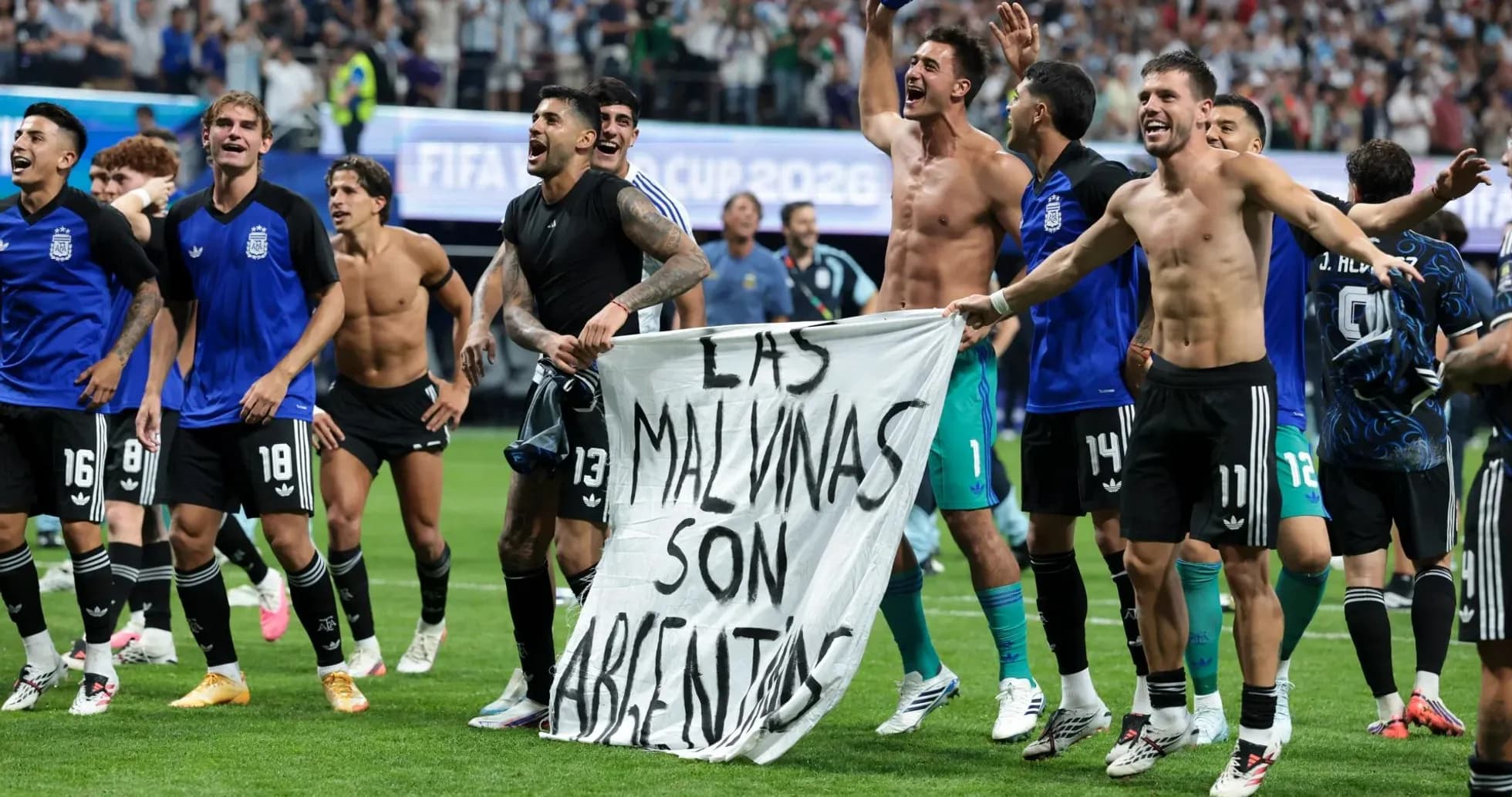 Argentina players celebrating with banner after match