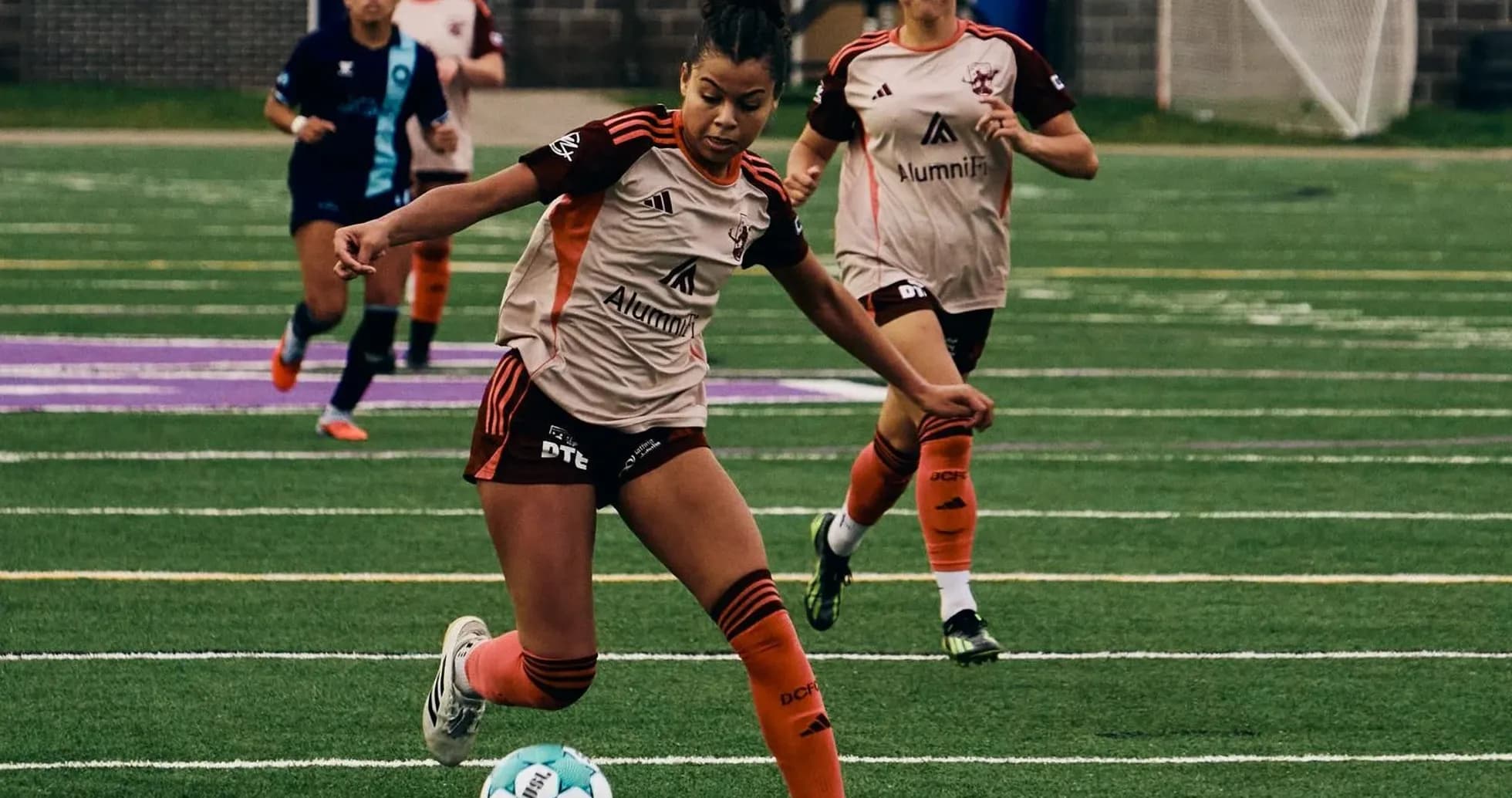 Player dribbling ball during Detroit City match