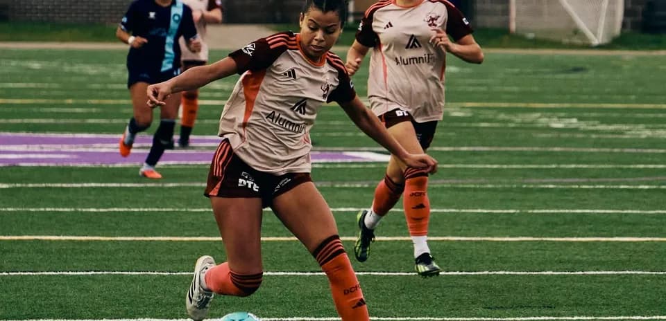 Player dribbling ball during Detroit City match