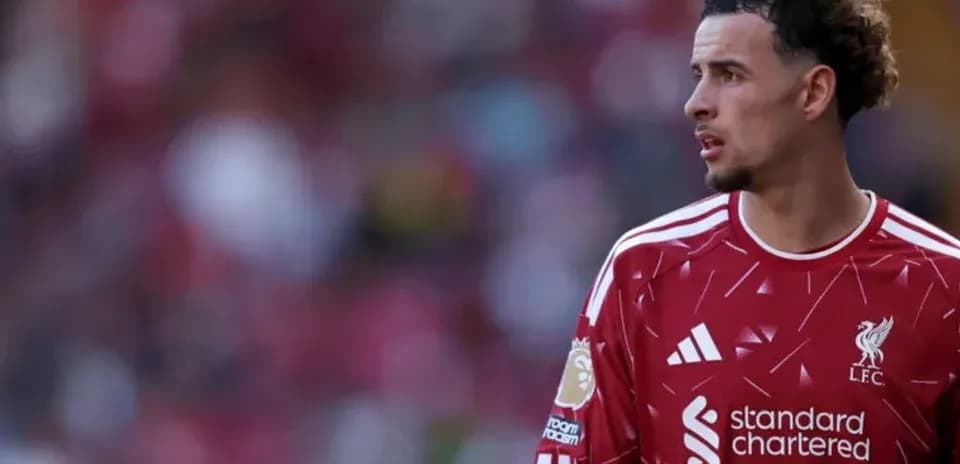 Liverpool player in red kit on the pitch