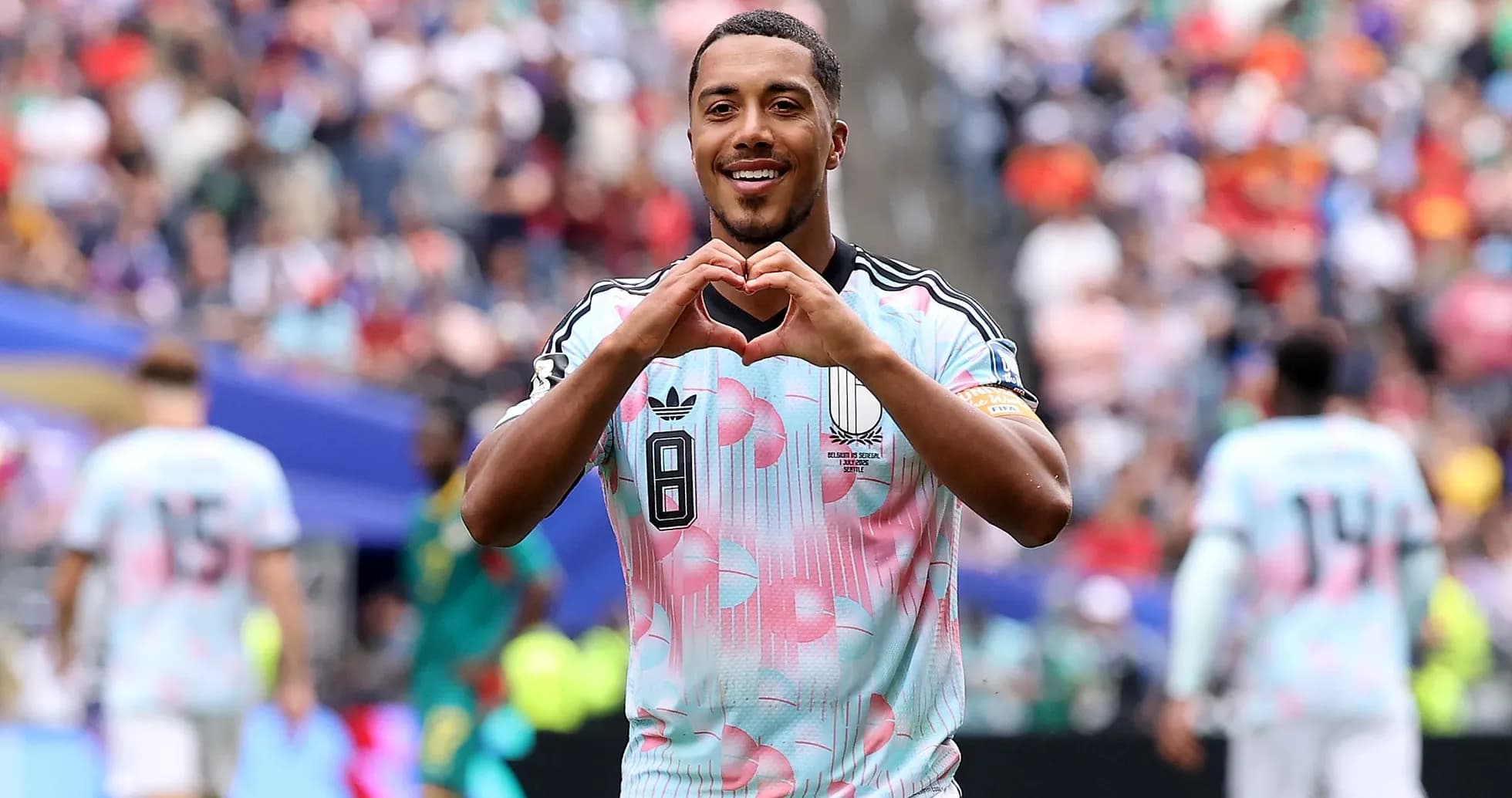 Player celebrating by making heart gesture on field
