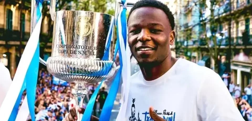 Player celebrating with trophy at victory parade