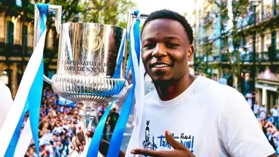 Player celebrating with trophy at victory parade