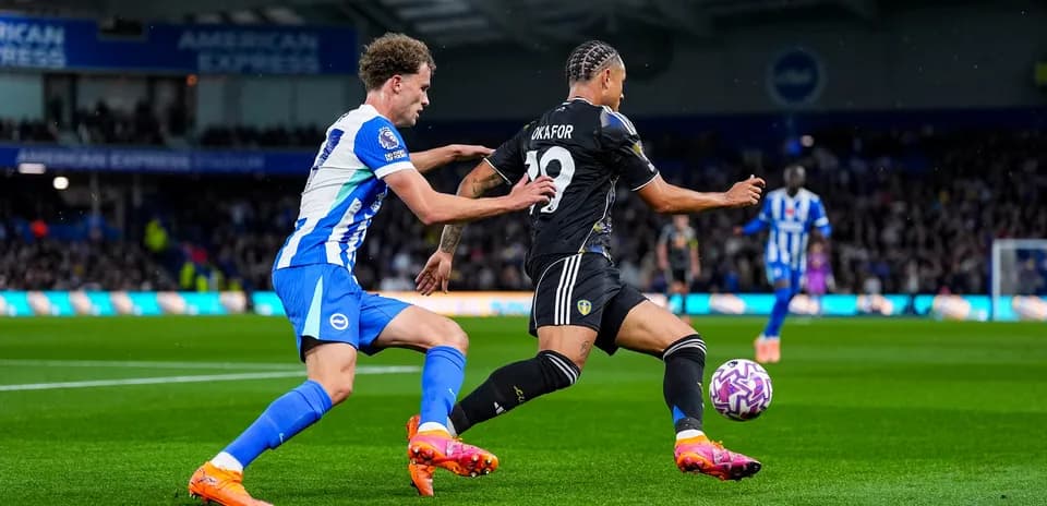 Leeds player challenged by Brighton defender