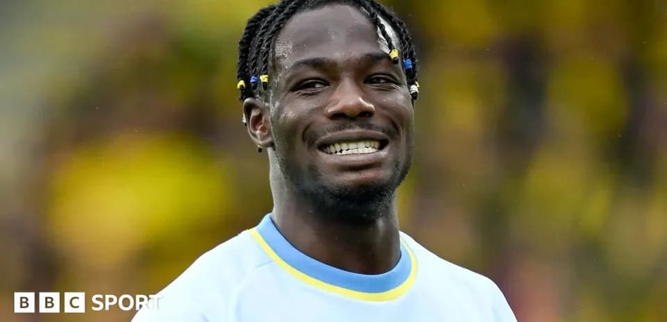 Player smiling in team jersey during match