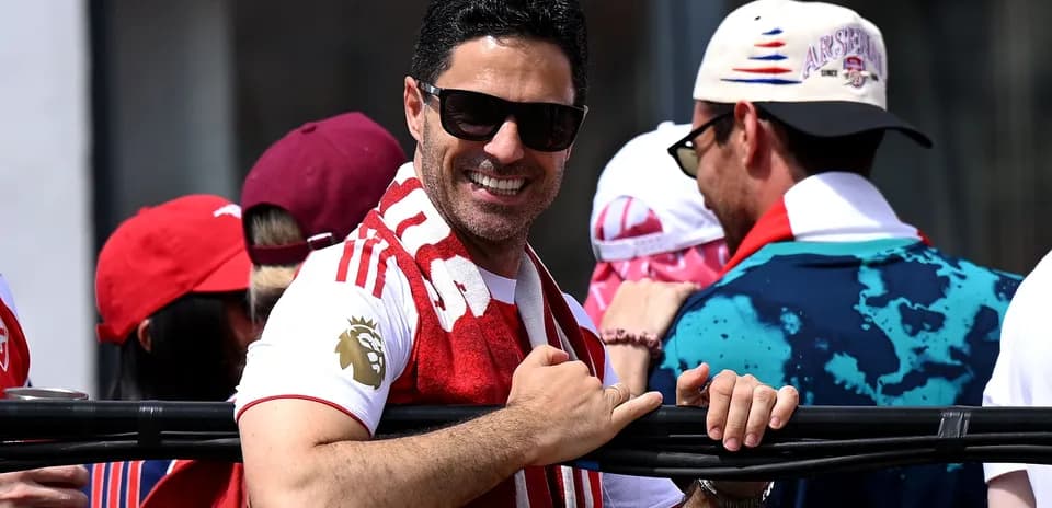 Man in sunglasses smiling at a celebration event