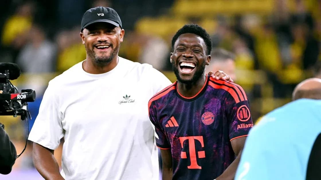 Two men smiling and laughing on the field