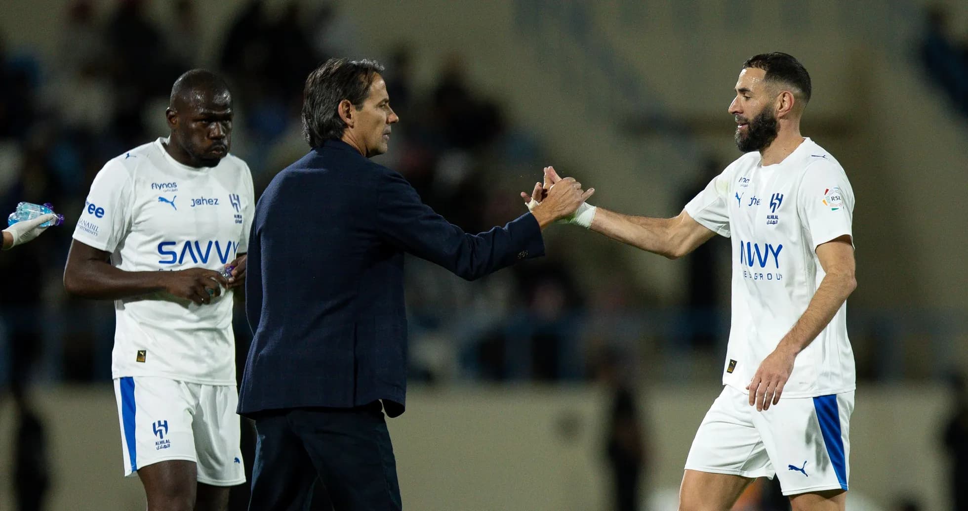 Coach shaking hands with player during match