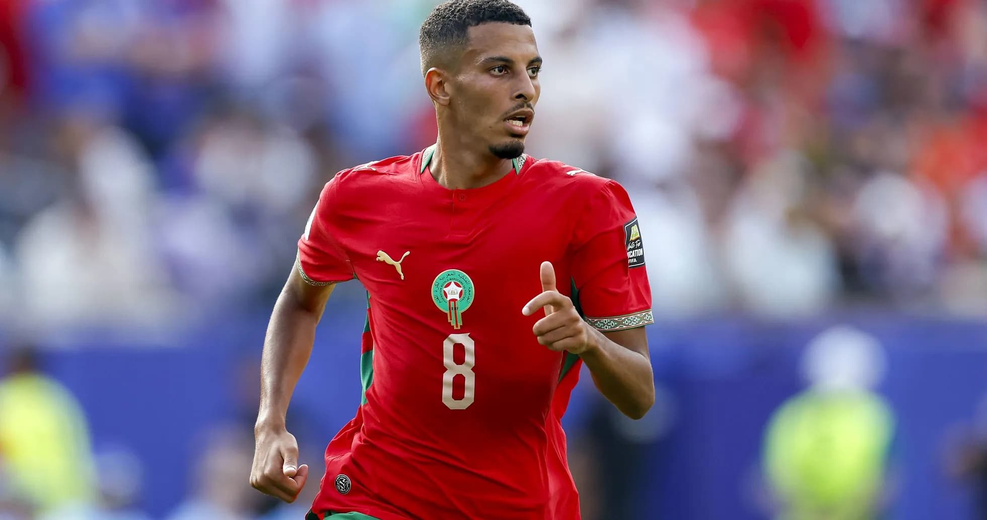 Moroccan player in red jersey running during match