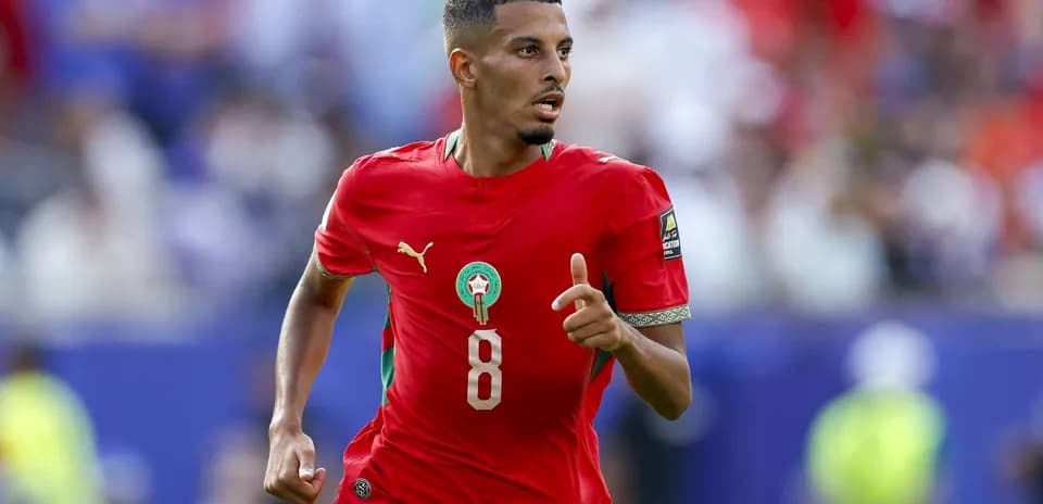 Moroccan player in red jersey running during match