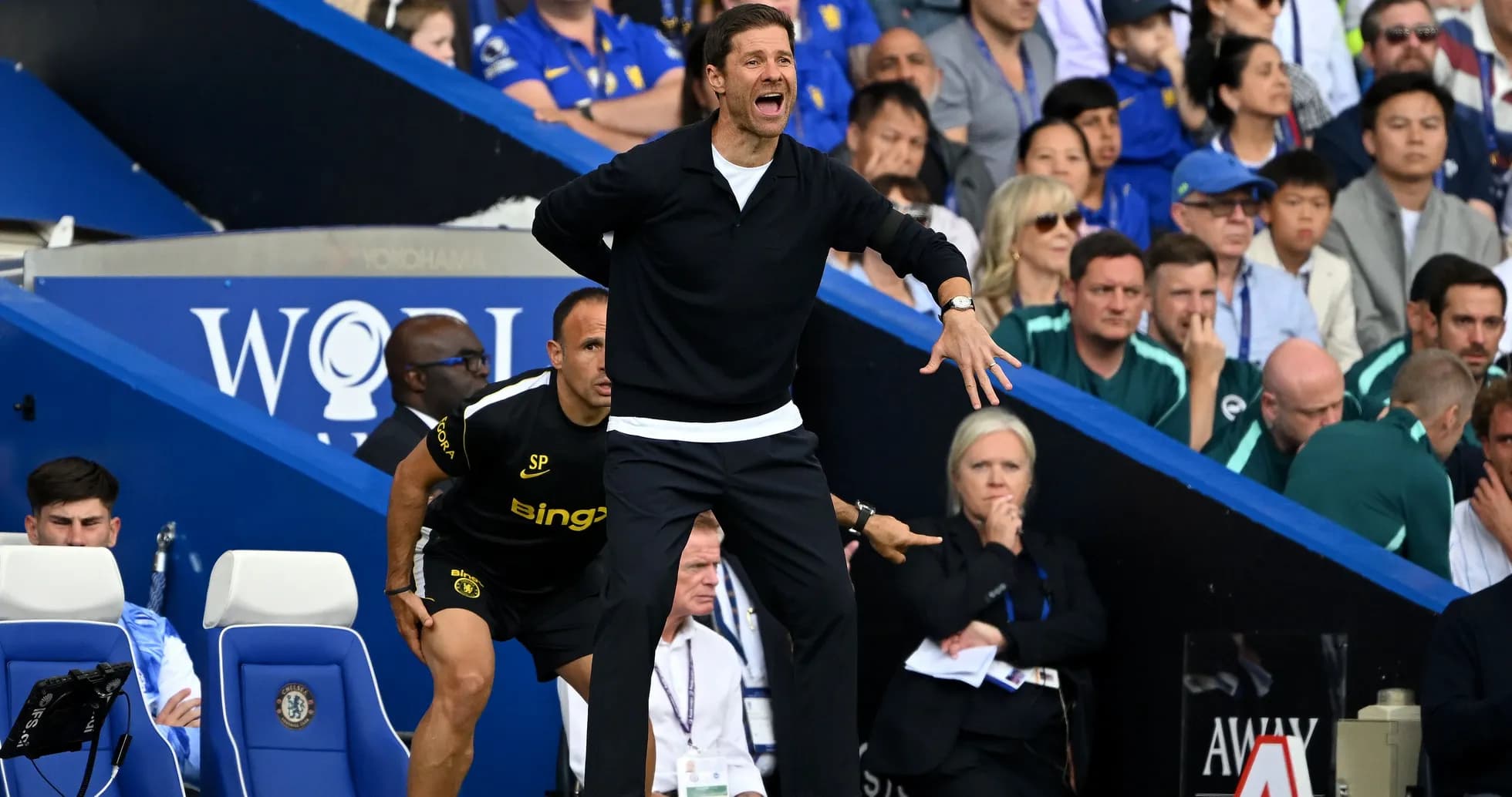 Coach directing players from the sidelines during match