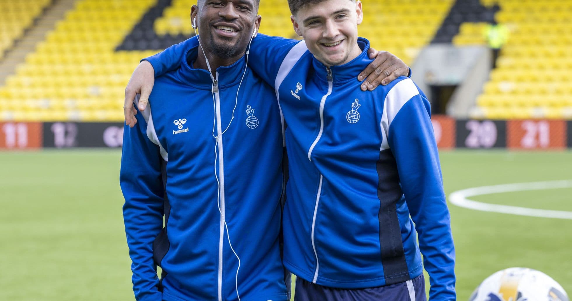 Two players posing together on training pitch