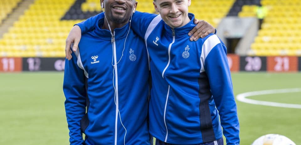 Two players posing together on training pitch