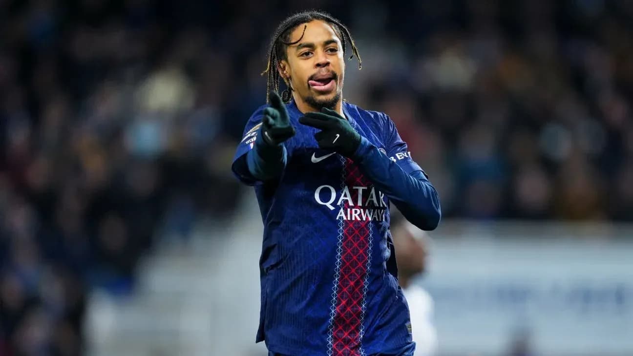 Player gesturing during match wearing PSG jersey