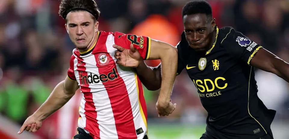 Brentford player tackling Chelsea opponent
