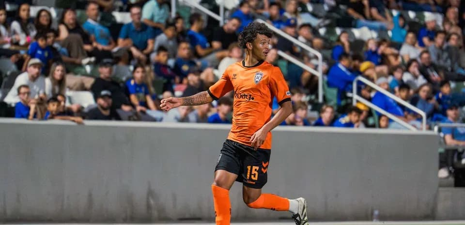 Player in orange jersey during football match