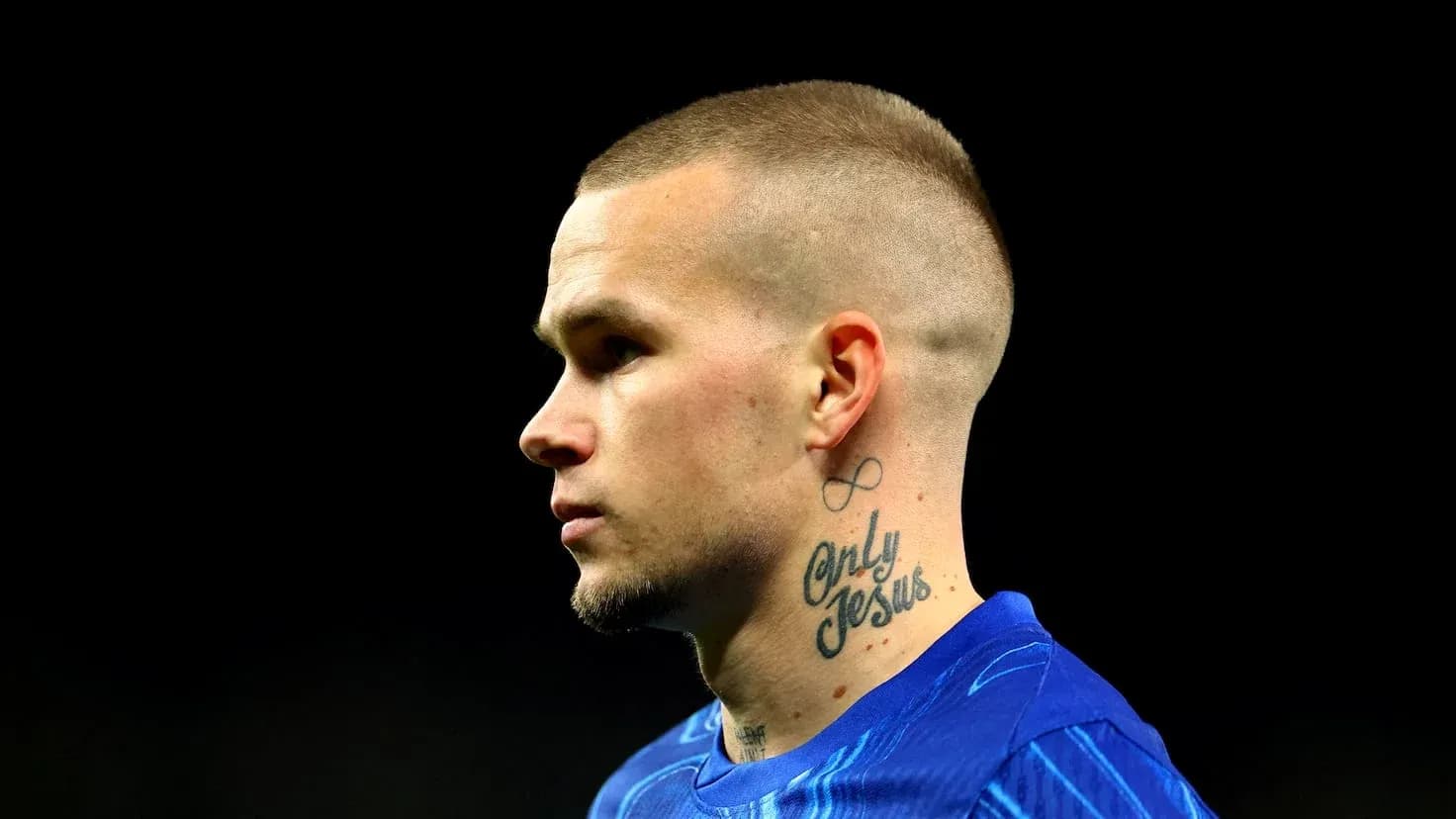 Player in blue jersey with tattoos on neck