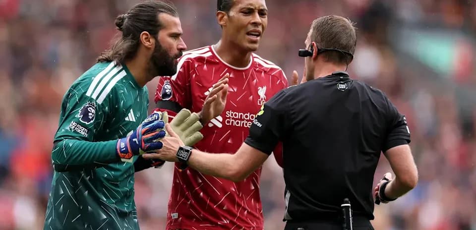Alisson and Van Dijk discussing with referee during match
