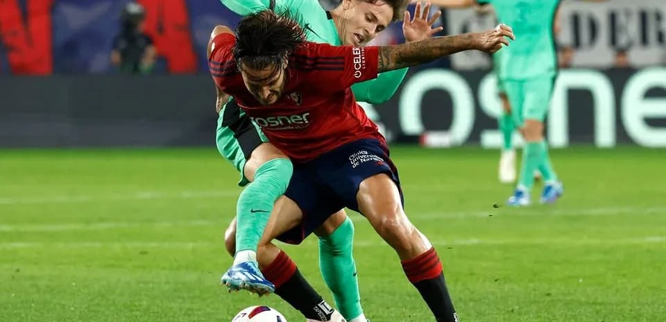 Osasuna player challenged by Atletico Madrid opponent