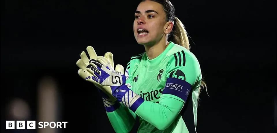 Goalkeeper in green uniform directing teammates during match