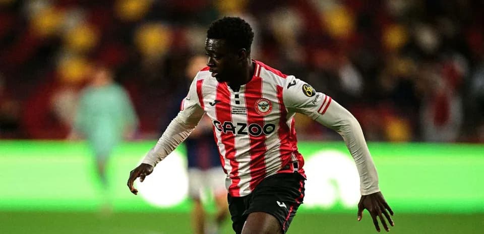 Player in Brentford kit running on the pitch