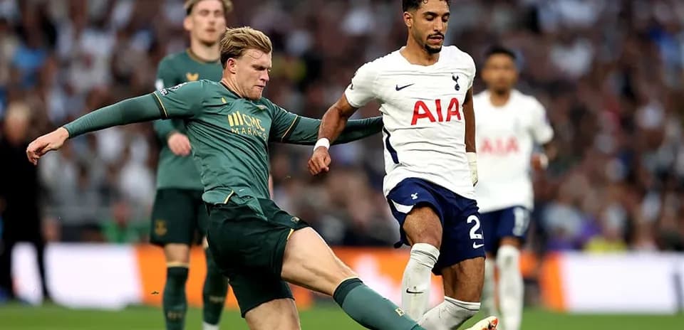 Player tackling opponent during football match action