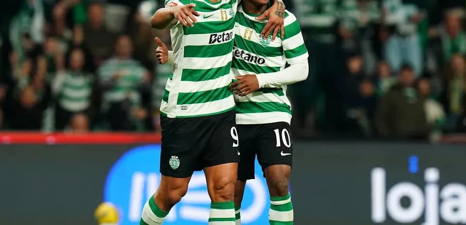 Two Sporting CP players celebrating on the field