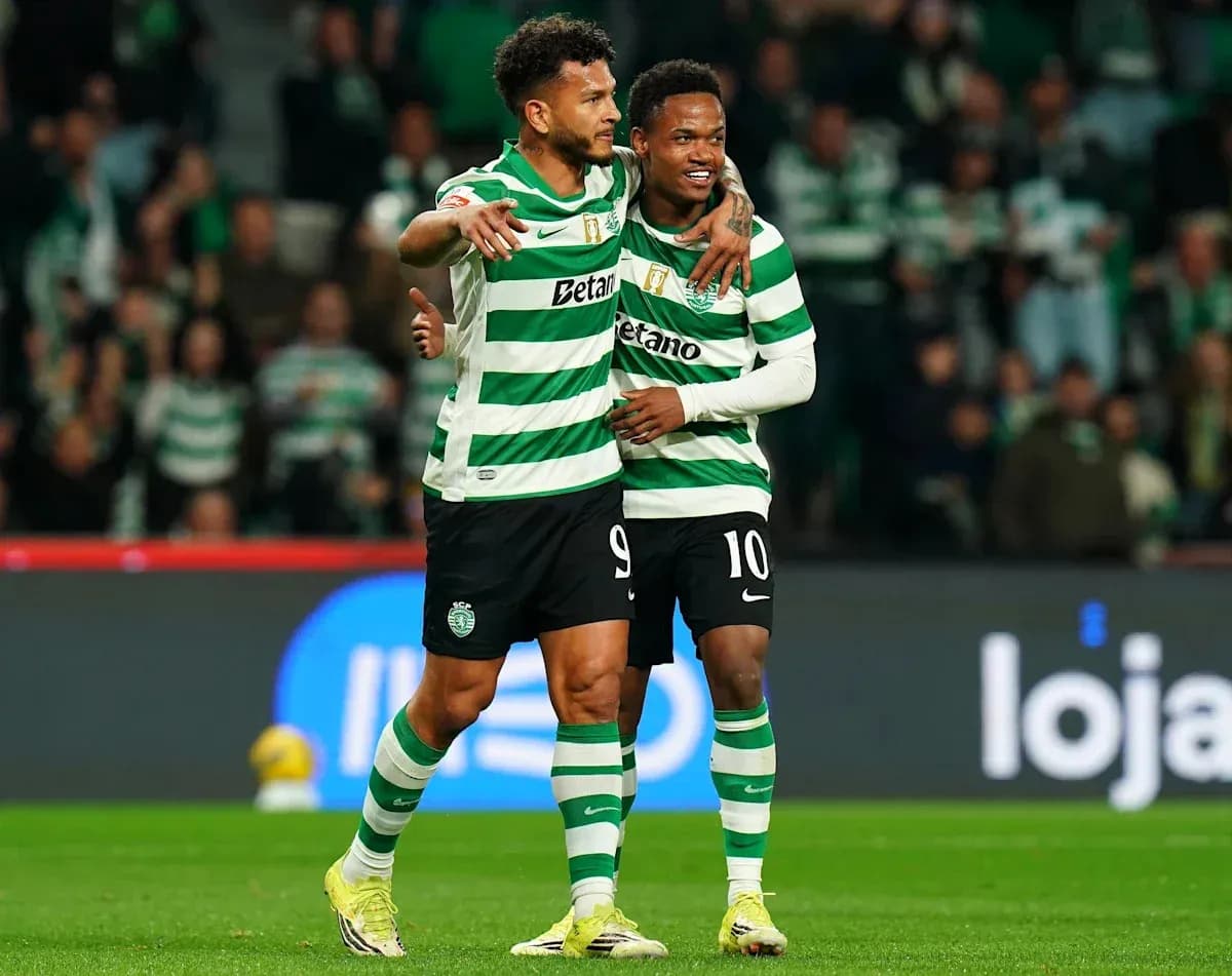 Two Sporting CP players celebrating on the field