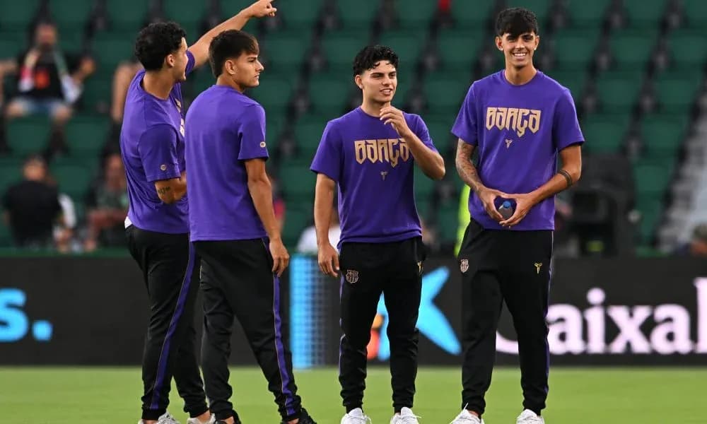 Players warming up in purple jerseys on field