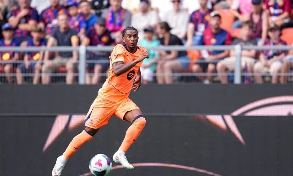 Player in orange kit running on the field